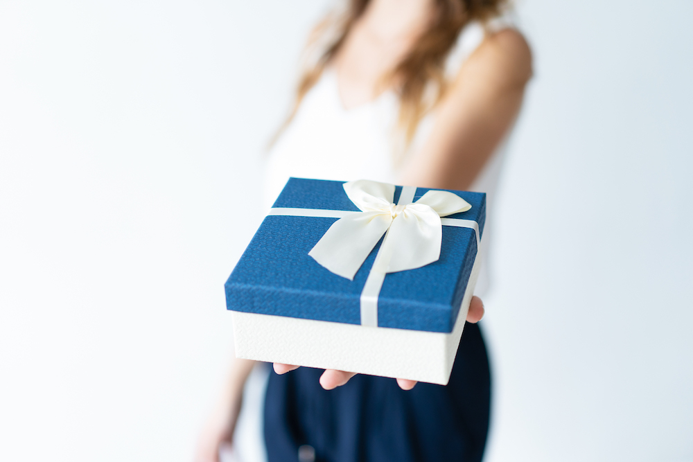 Closeup of woman holding gift box on palm